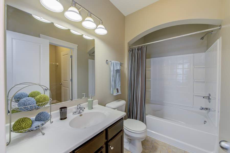 In shared spaces like this bathroom at The District at Saxony Apartments, it's important to be respectful and keep it clean for others. Full bath with vanity in apartment