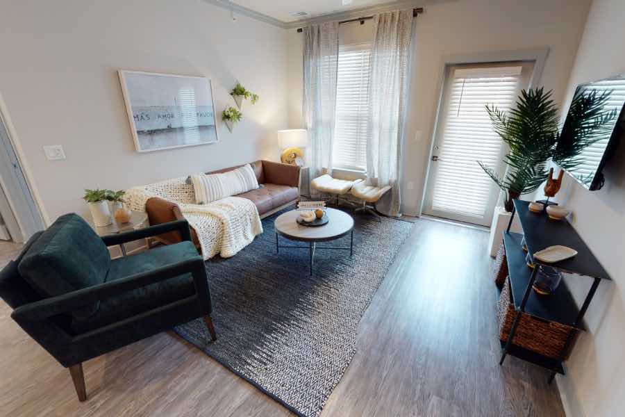 Renters insurance will help you replace furnishings like the ones seen here at Verge Apartments in Greenwood. Sofa, chairs, tables, and wall decor in apartment living room