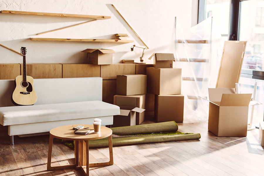 Save money on moving by discarding or donating items you don't need and obtaining boxes from businesses, friends, or family. Storage boxes used in moving to a new apartment