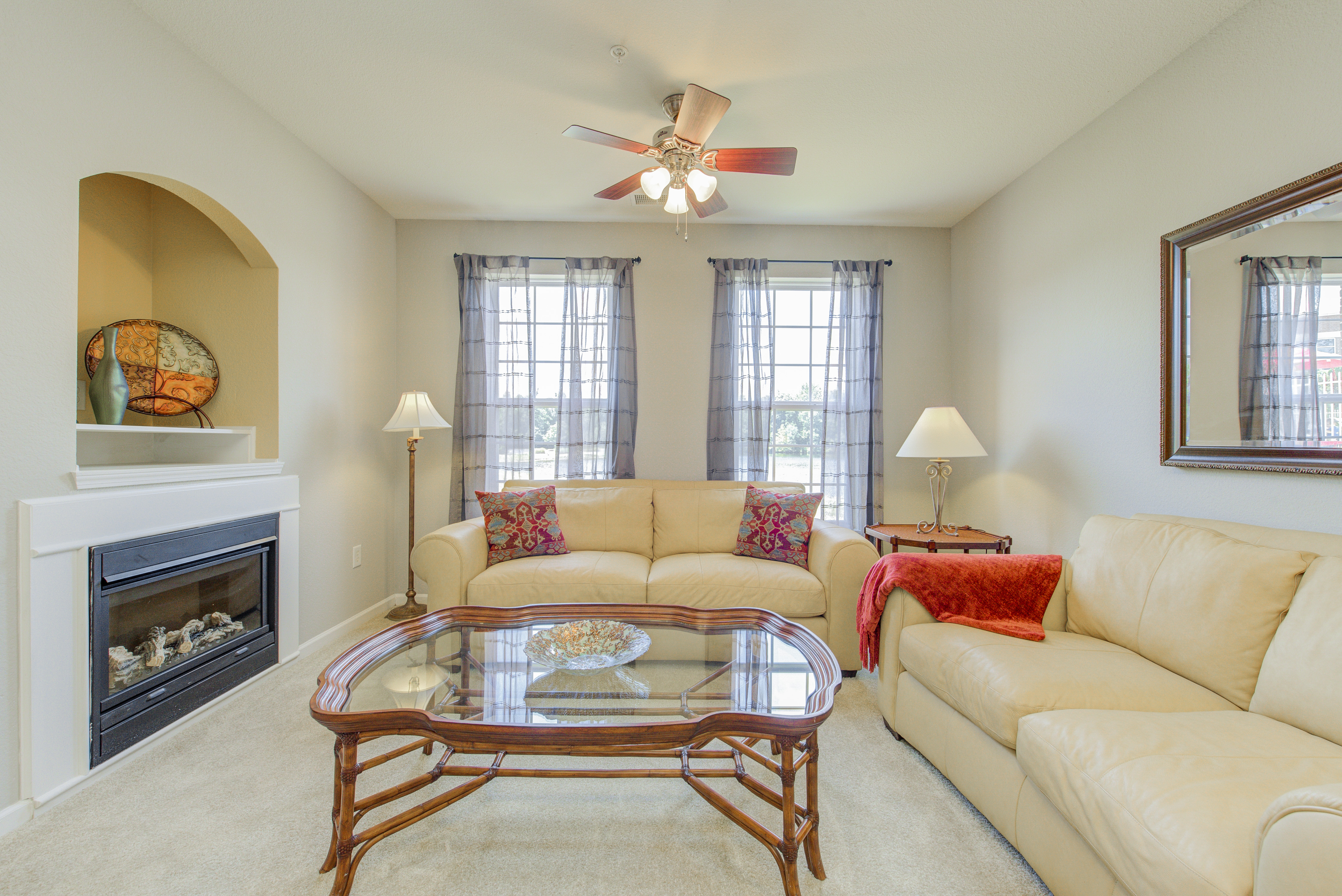 Neutral color schemes like this one in a living room at North Haven Apartments help set a minimalist tone. Living room in neutral colors with fireplace and matching furniture