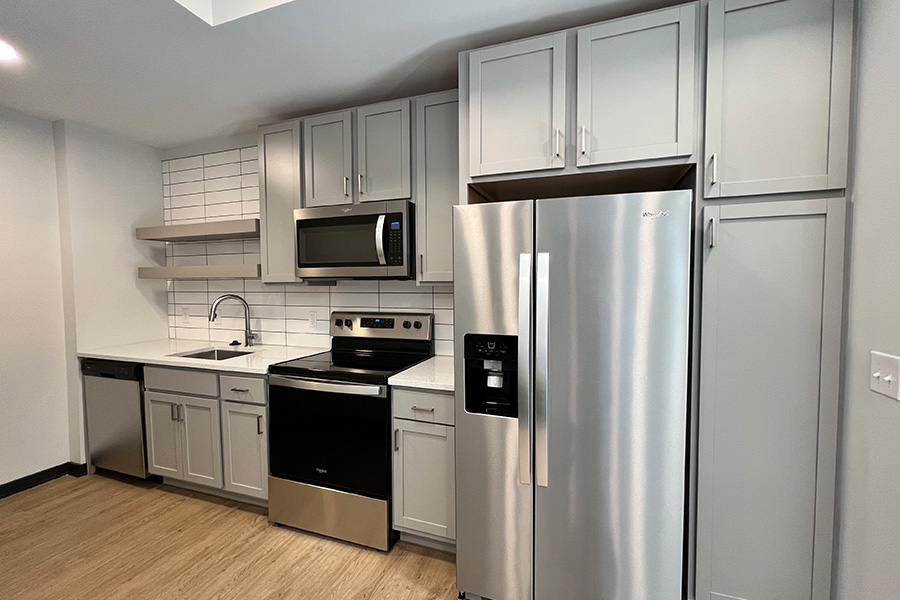 In kitchens like this one at Block 20 Apartments, you can adjust how you use appliances to lower energy consumption. Stainless steel appliances in kitchen of Indianapolis apartment
