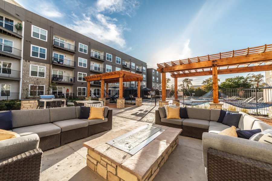 Moving to a new community means you'll get access to lovely features like this outdoor seating area at The Verge. Outdoor seating with a fire table and pergolas