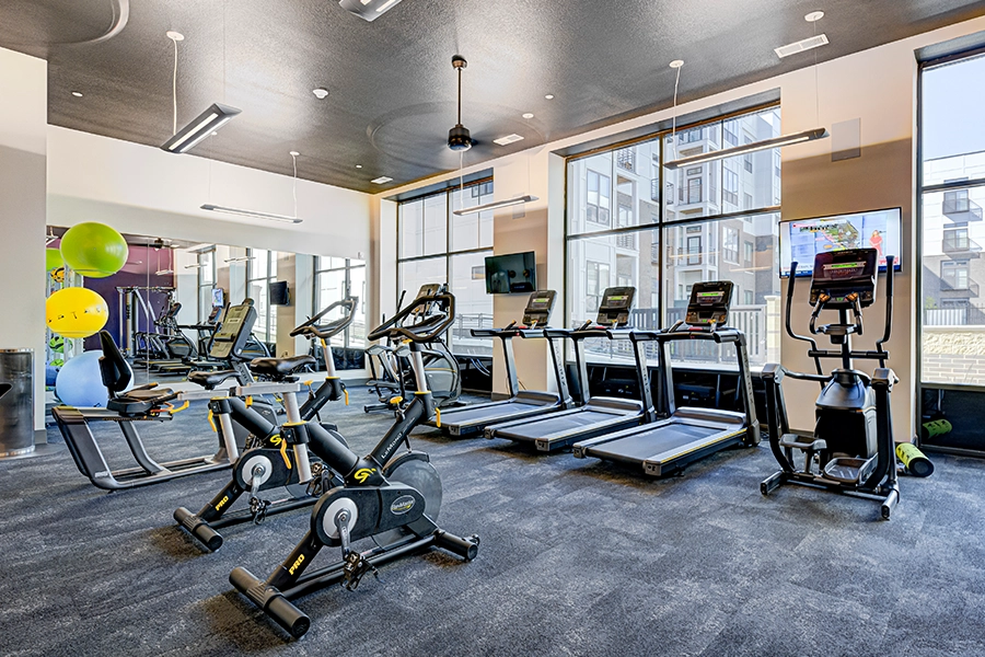 J.C. Hart is committed to offering upscale amenities like this fitness center at Continuum Apartments in West Lafayette. Apartment fitness center with a variety of cardio equipment