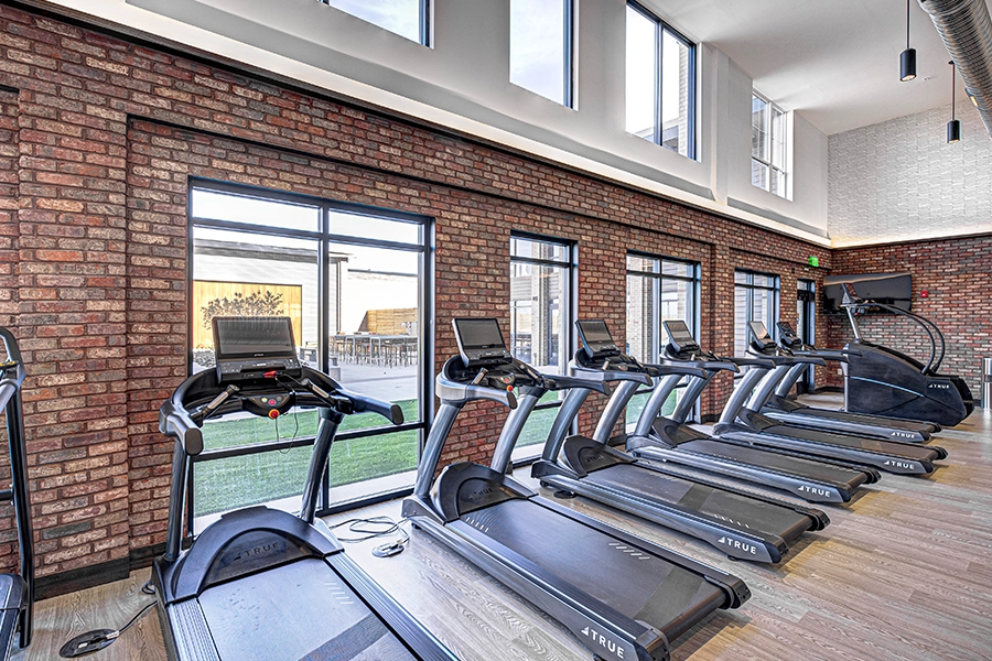 Apartment amenities like this fitness center at State at Fishers will add to your enjoyment of your new community. Treadmills at apartment fitness center in Fishers