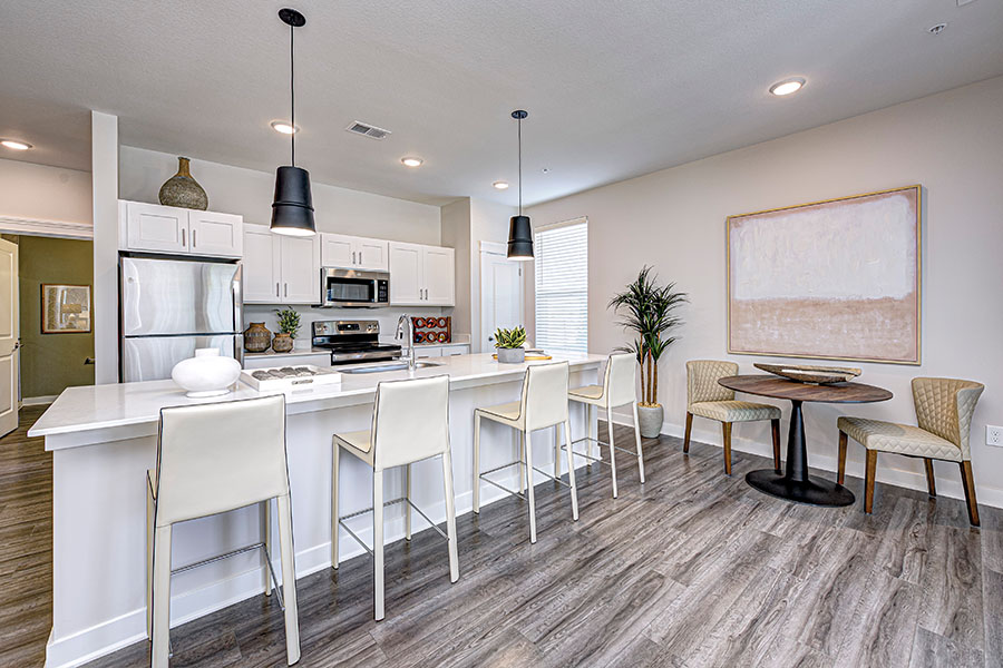 Kitchen with bar seating  in a unit at Wheelhouse Apartments on the Monon