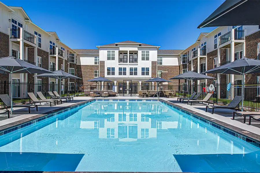 Not sure what a community means by amenities? This pool at Crossing 5 Apartments is one example of an amenity. Pristine pool surrounded by apartment buildings at Crossing 5 Apartments.